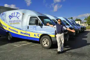 About Us | Beltz Home Service Co. A Man Poses Proudly With A Fleet Of Blue And White Service Vans Labeled &Quot;Beltz Home Service Co.,&Quot; Showcasing Services Like Plumbing, Heating, And A/C. Discover More About Us And Our Commitment To Exceptional Home Solutions.